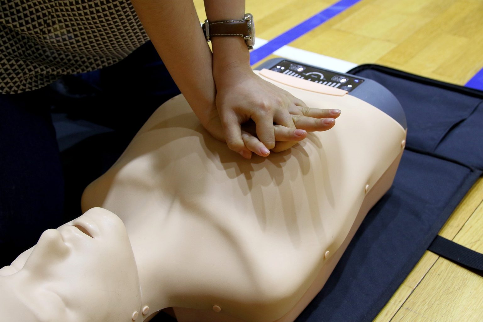 Proper hand position for chest compressions while leaning over the center of the chest.